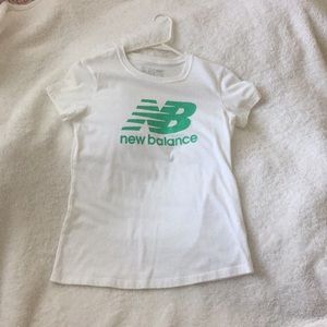 White and green New Balance tee.